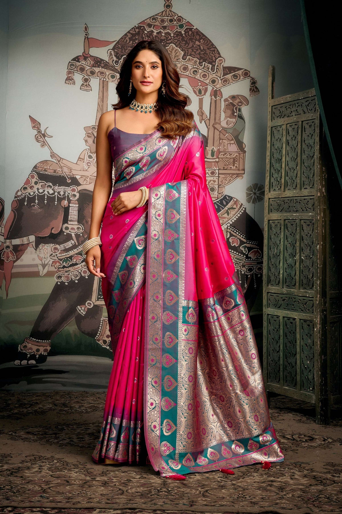 Pink soft silk saree with Zari woven detail and matching blouse piece.