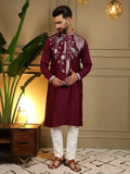A front view of a maroon men's kurta with detailed sequins embroidery paired with a matching pajama.