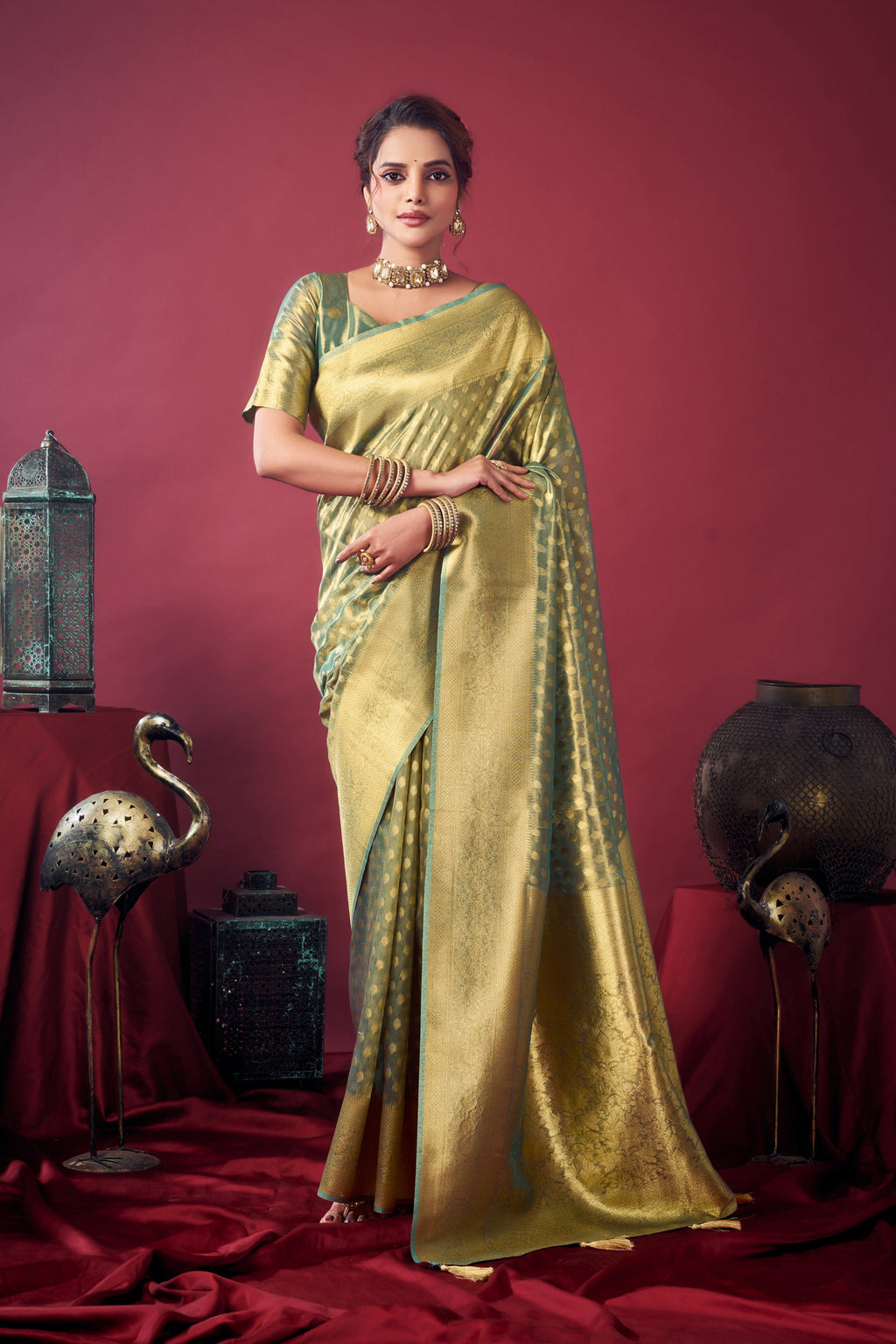 Grey tissue silk saree with intricate Zari woven border and jhalar details, includes matching blouse fabric.
