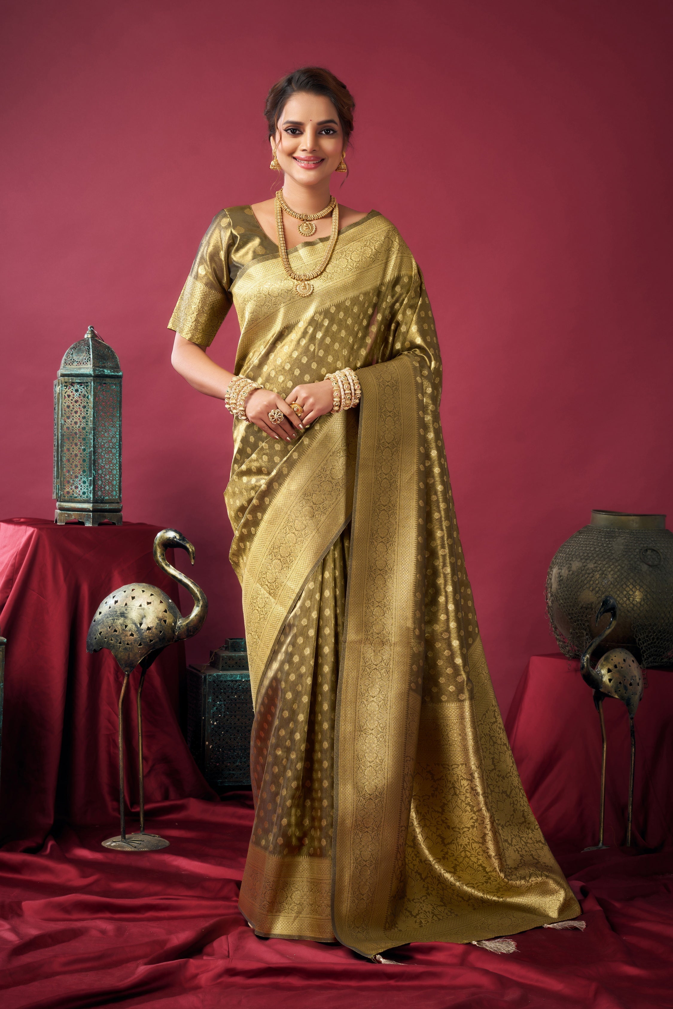 Mehendi color tissue silk saree featuring intricate zari weaving and jhalar hem