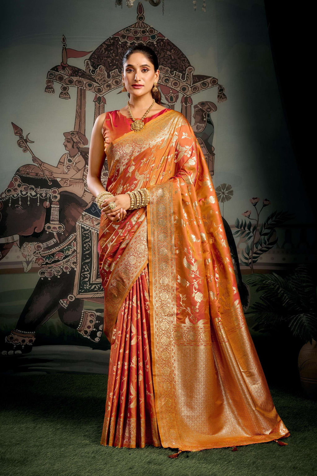 Orange premium soft silk saree with Zari woven detailing and Jhalar border.