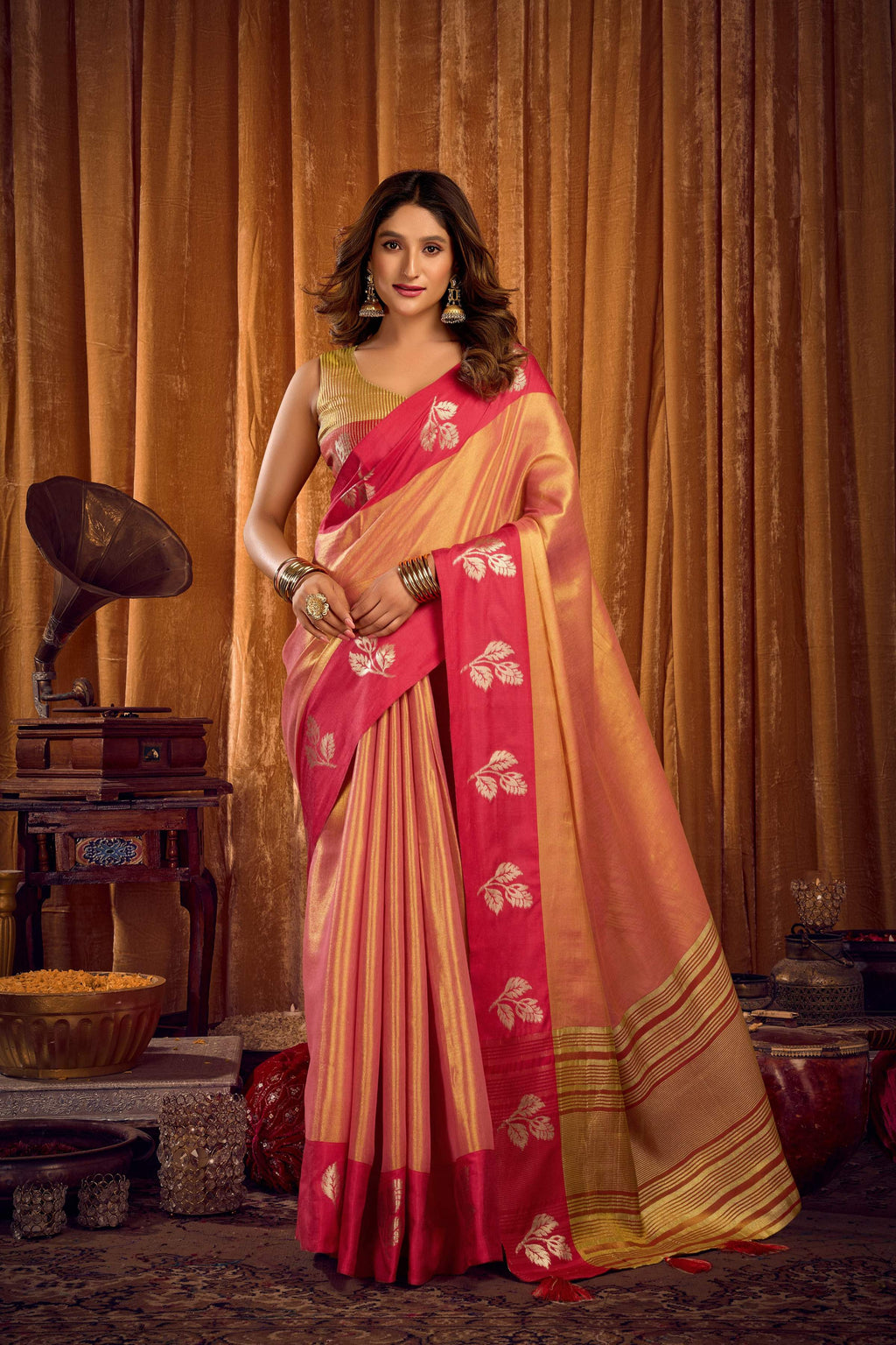 Peach soft tissue saree with woven zari border and decorative jhalar