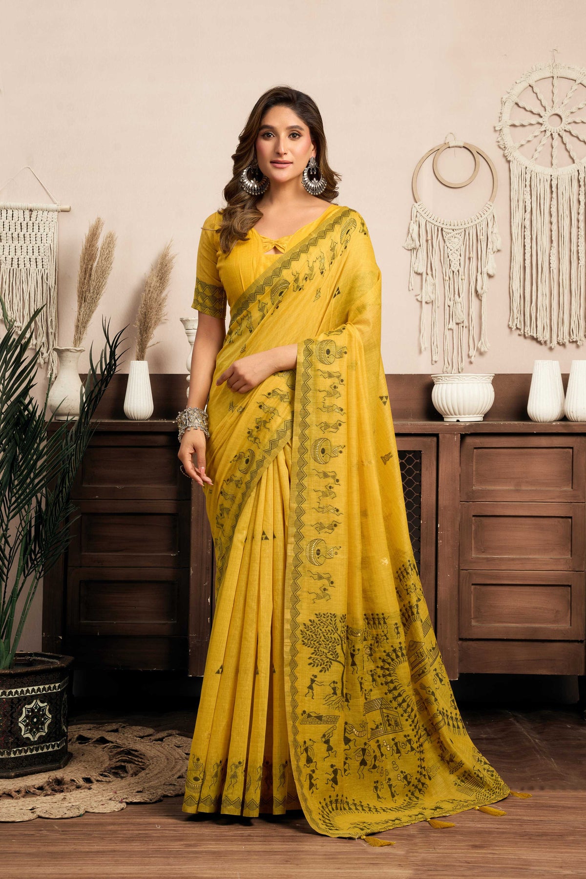 Mustard yellow art silk saree with traditional Warli patterns and jhalar detailing