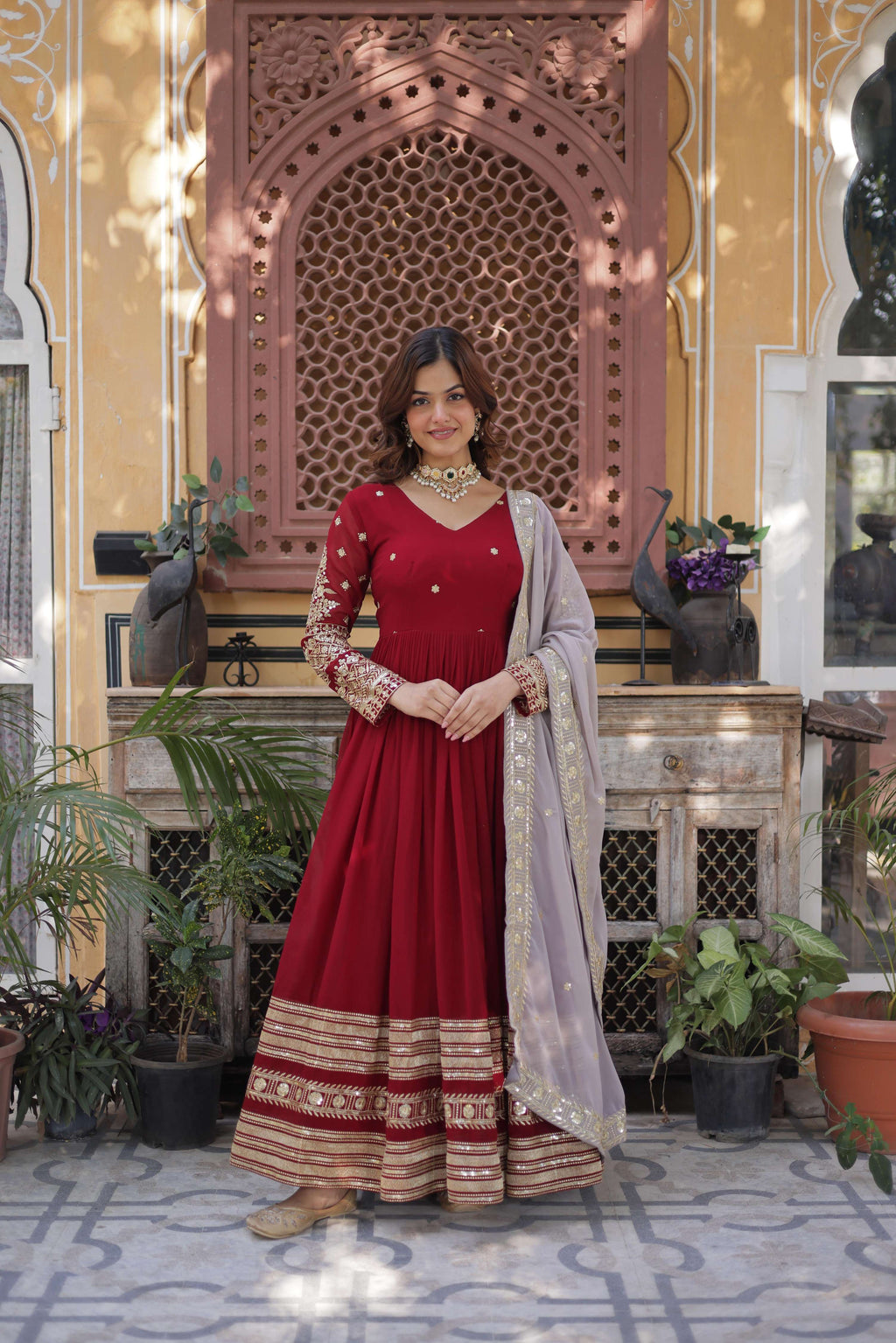 Maroon Anarkali set made of Faux Blooming fabric with intricate zari and sequins embroidery.