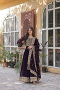 Model wearing a wine-colored Faux Blooming Anarkali set with gold zari embroidery and matching dupatta