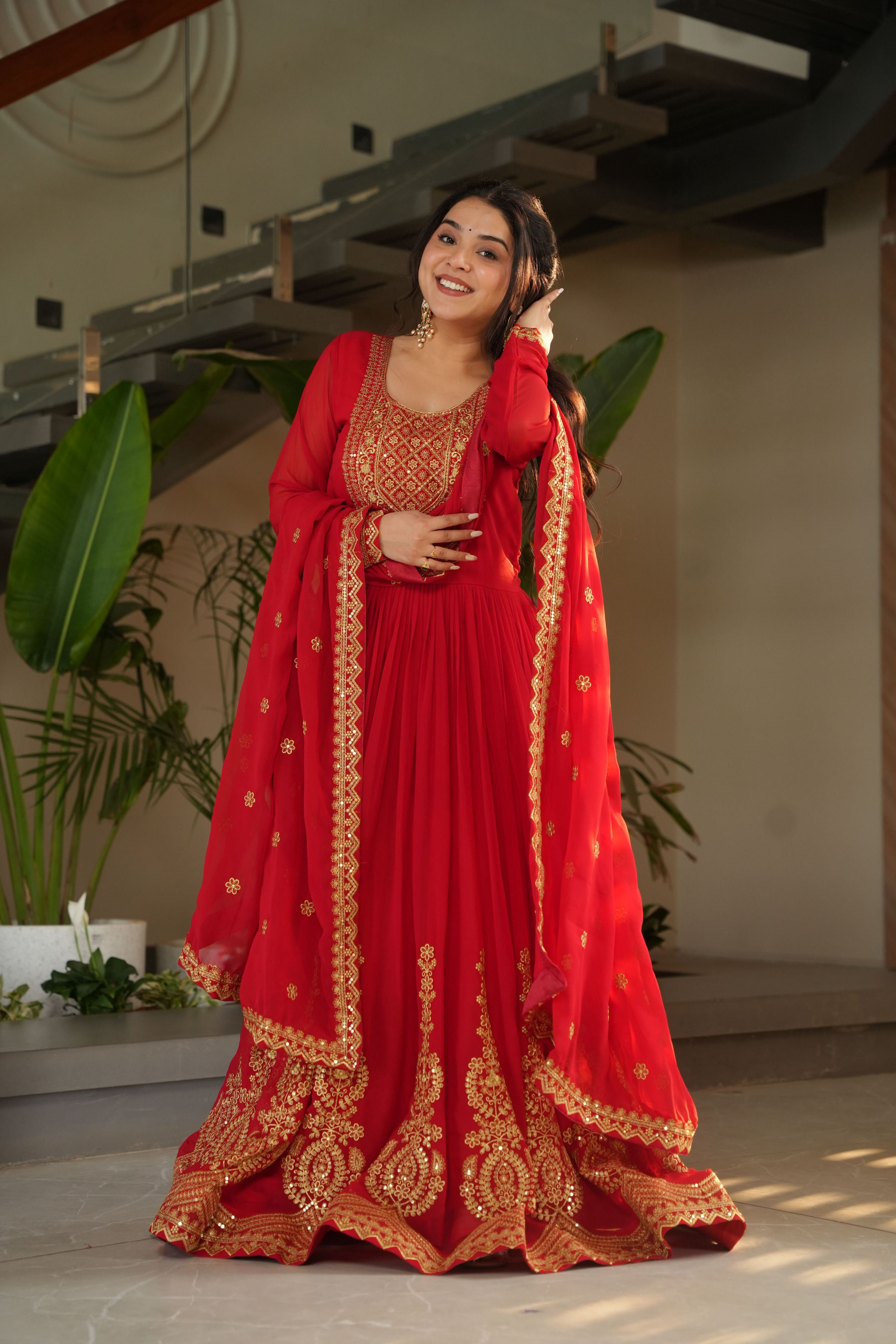 Red Faux Blooming Anarkali set featuring heavy zari and sequins embroidery with a large flare.