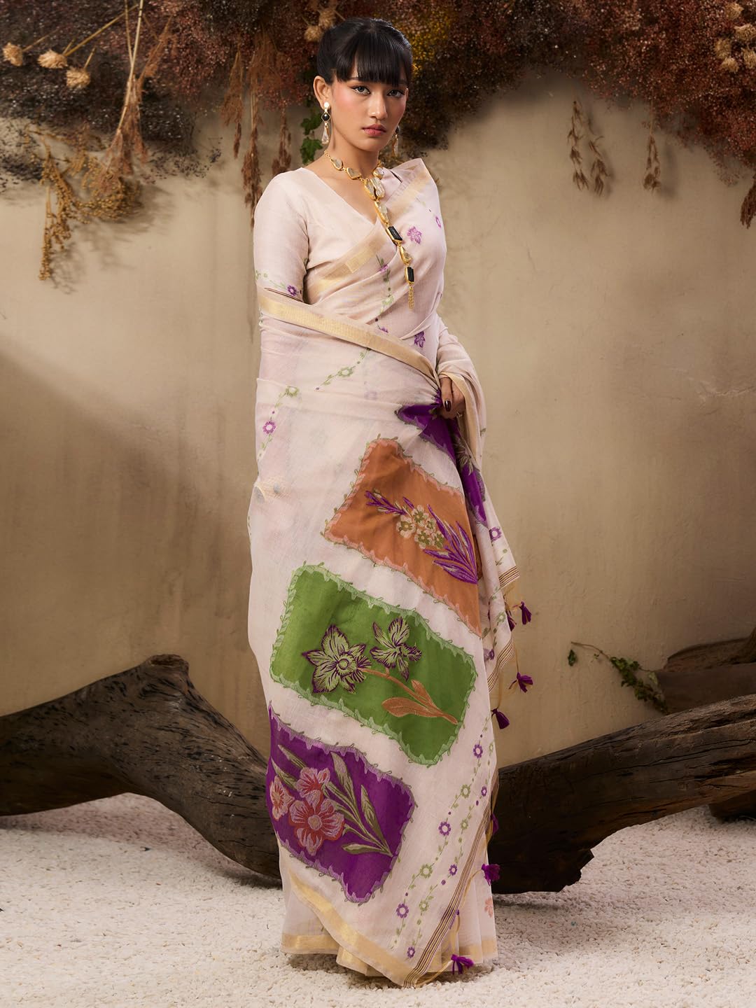Close up of a wine-colored soft muga cotton saree featuring fine resham weaving details