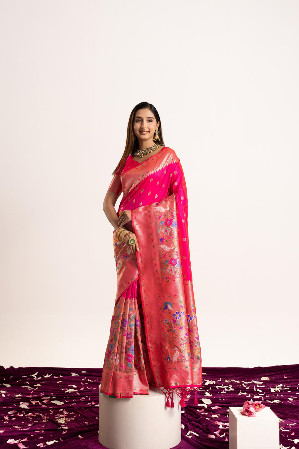 A beautiful pink Banarasi silk saree featuring delicate Zari woven patterns and a matching blouse piece.