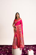 A beautiful pink Banarasi silk saree featuring delicate Zari woven patterns and a matching blouse piece.