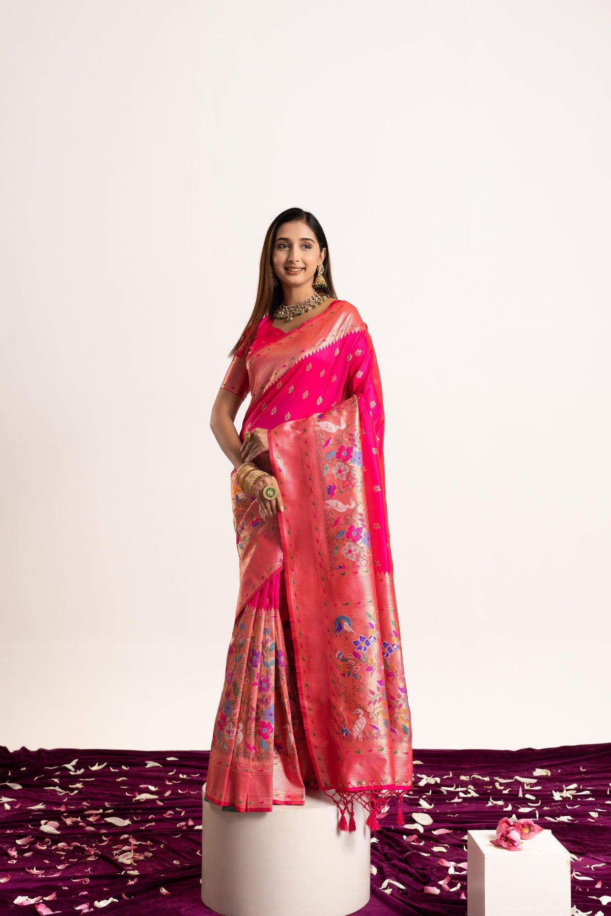 A beautiful pink Banarasi silk saree featuring delicate Zari woven patterns and a matching blouse piece.