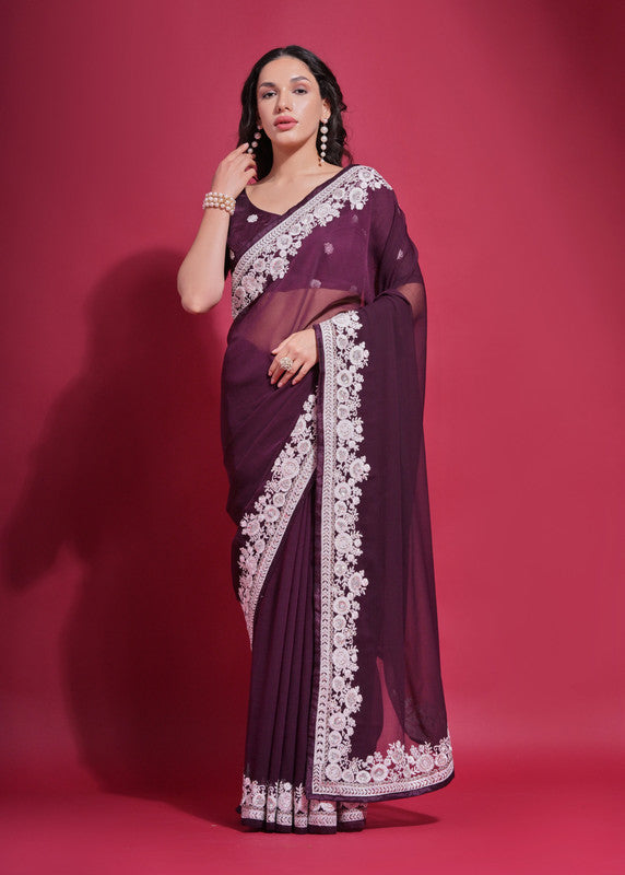 A beautiful wine-colored georgette saree with detailed coding work and a matching blouse.