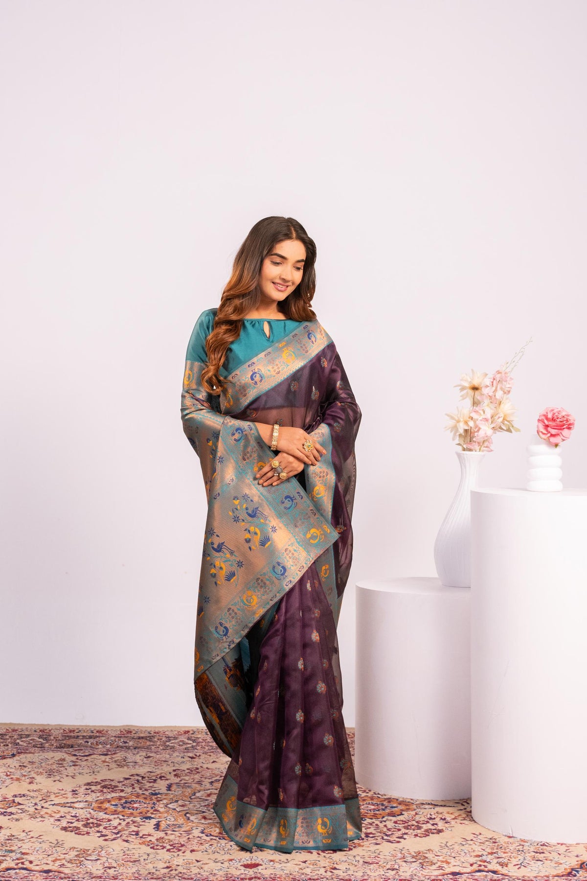 Wine colored soft tissue silk saree with intricate gold zari woven details and matching blouse