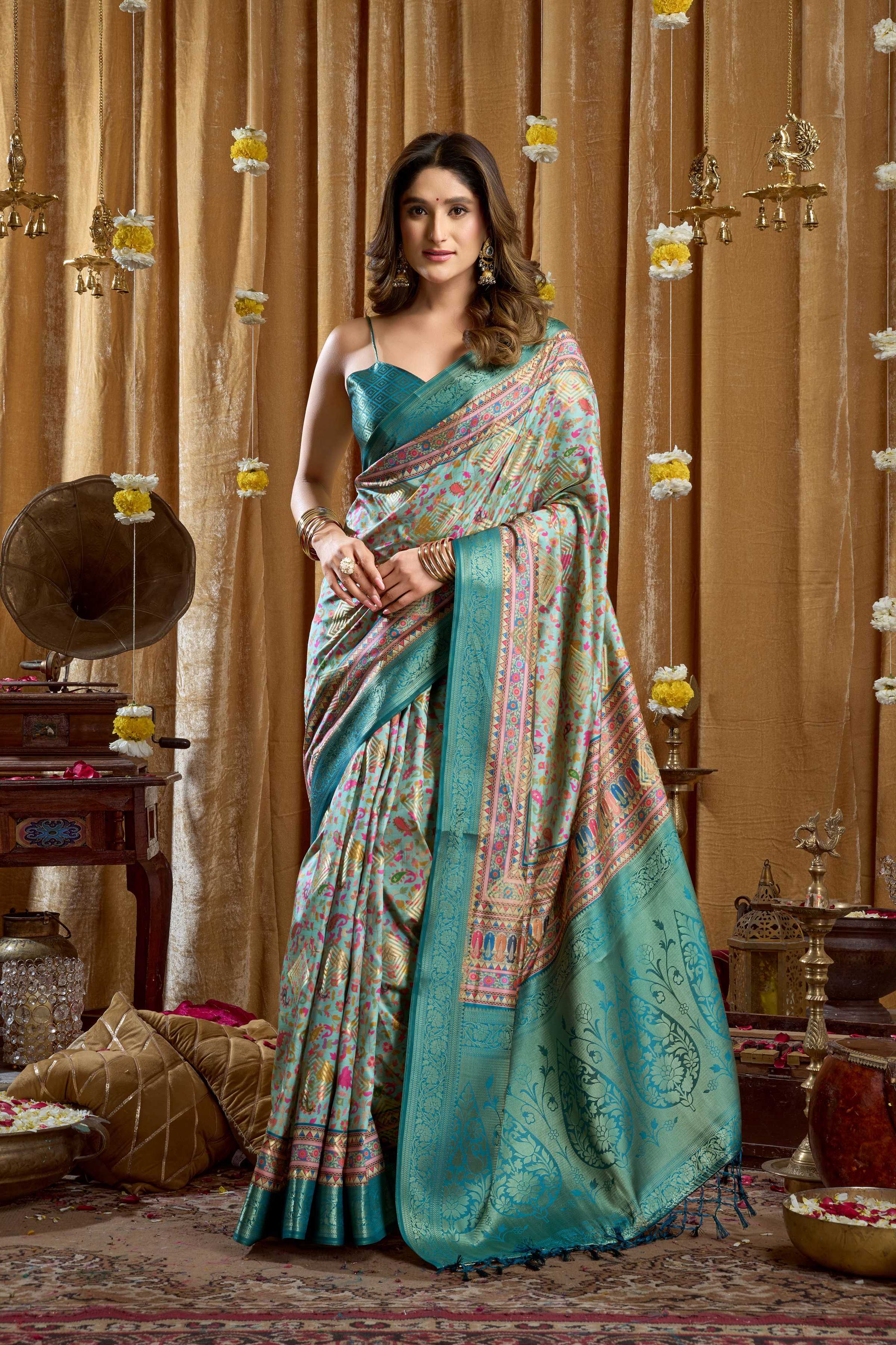 Turquoise Banarasi saree with digital cluster print and tassels, includes matching blouse