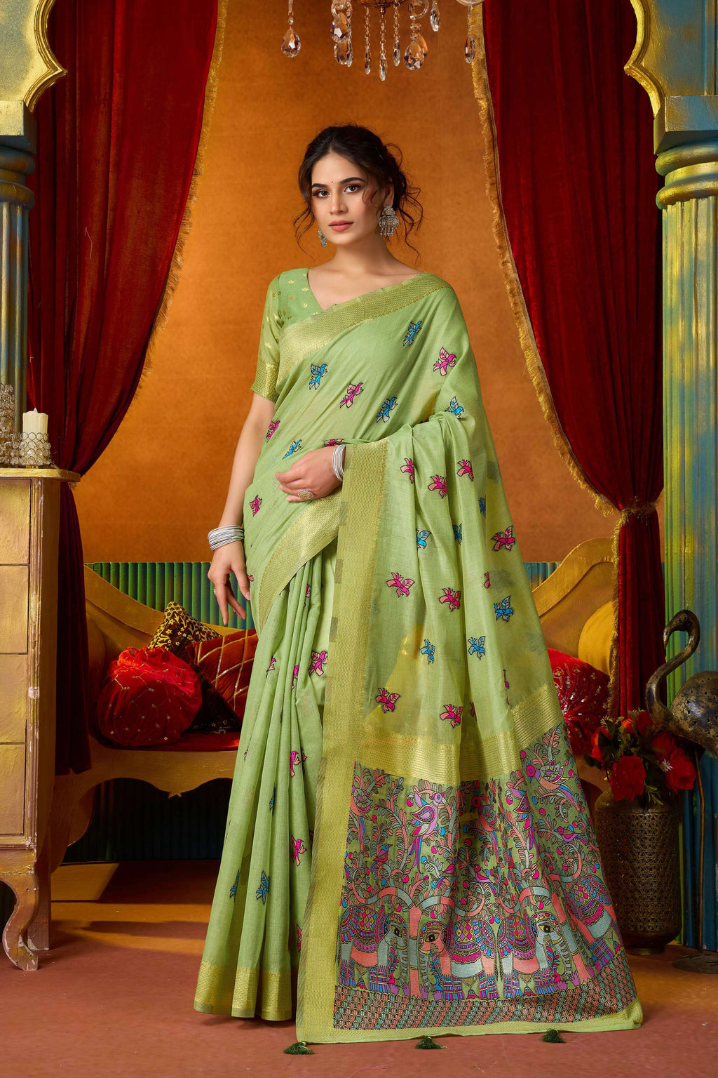 Elegant green modal saree featuring intricate gold zari woven borders with matching blouse piece