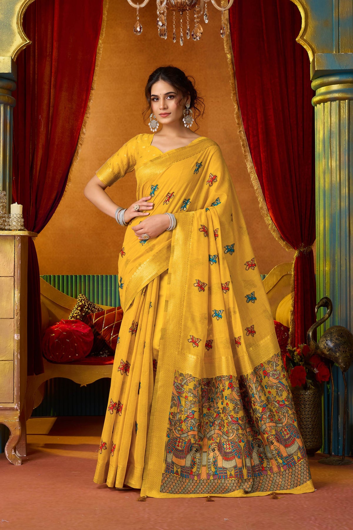 A vibrant yellow modal saree with intricate zari woven patterns and a matching blouse piece.