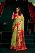 Green tissue Paithani saree with lotus motifs in zari and meena work.