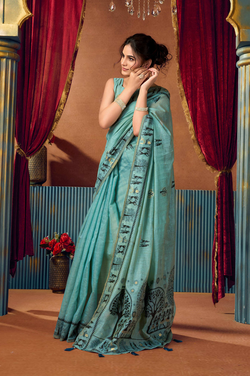 Vibrant turquoise modal saree with shimmering zari woven details and matching blouse