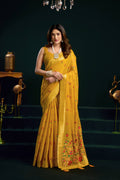 Yellow muga cotton saree featuring colorful meena zari woven borders and matching blouse piece