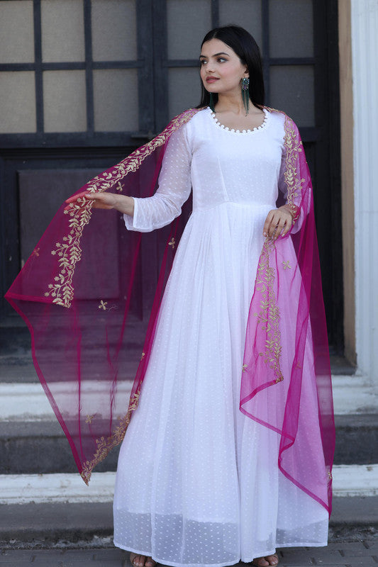 White faux georgette Anarkali dress featuring butti work and elegant potli finishing.