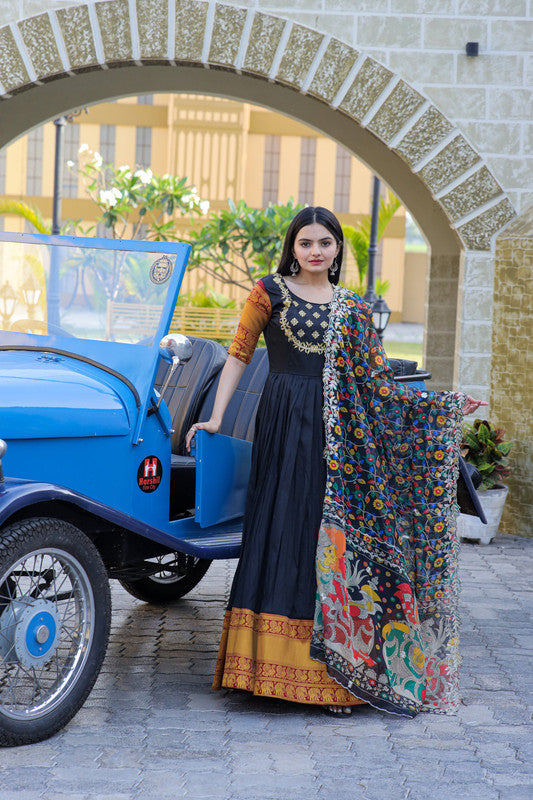 Black silk Anarkali dress with intricate jacquard weaving and gold embroidery.