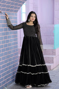 Woman wearing a black faux blooming Anarkali dress with silver zari and sequins embroidery