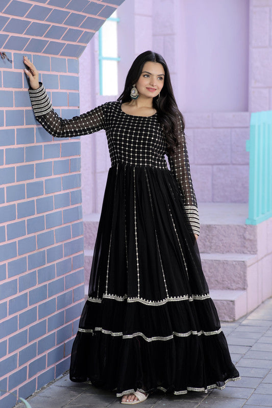Woman wearing a black faux blooming Anarkali dress with silver zari and sequins embroidery
