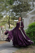 Woman wearing a purple 5-layer frill floor-length Anarkali dress with silver accents and dupatta