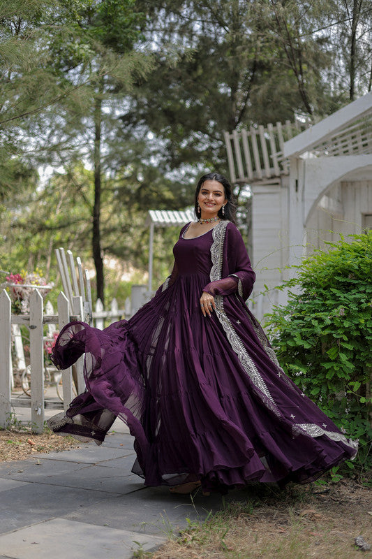 Woman wearing a purple 5-layer frill floor-length Anarkali dress with silver accents and dupatta
