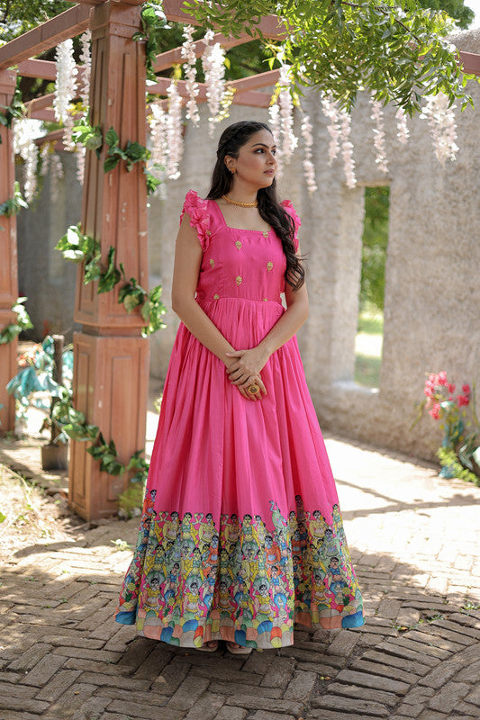 Women wearing a floor-length pink printed Dola Silk Anarkali dress for festive events