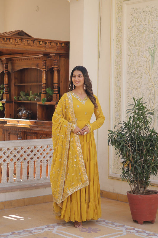 Yellow faux georgette Anarkali dress with embroidery and matching dupatta, perfect for festive events.
