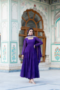 Woman wearing a floor-length purple faux georgette Anarkali dress with frill work and dupatta.