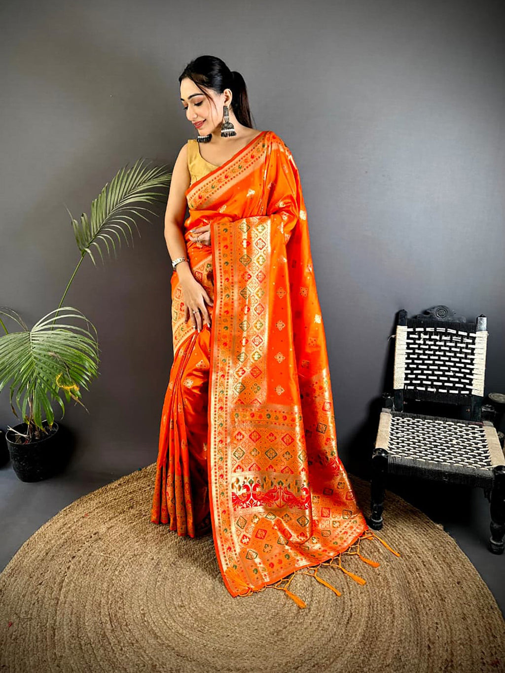 Vibrant orange Banarasi Lichi silk saree with intricate multi-colored Meenakari woven patterns