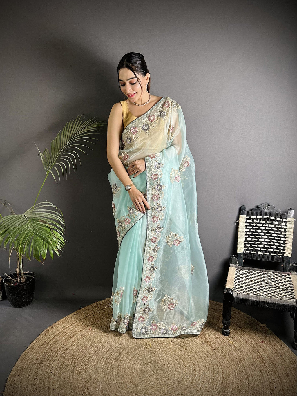 A beautiful Sky Blue Organza Silk saree featuring a double sequence pattern with a Baby Pink unstitched blouse.