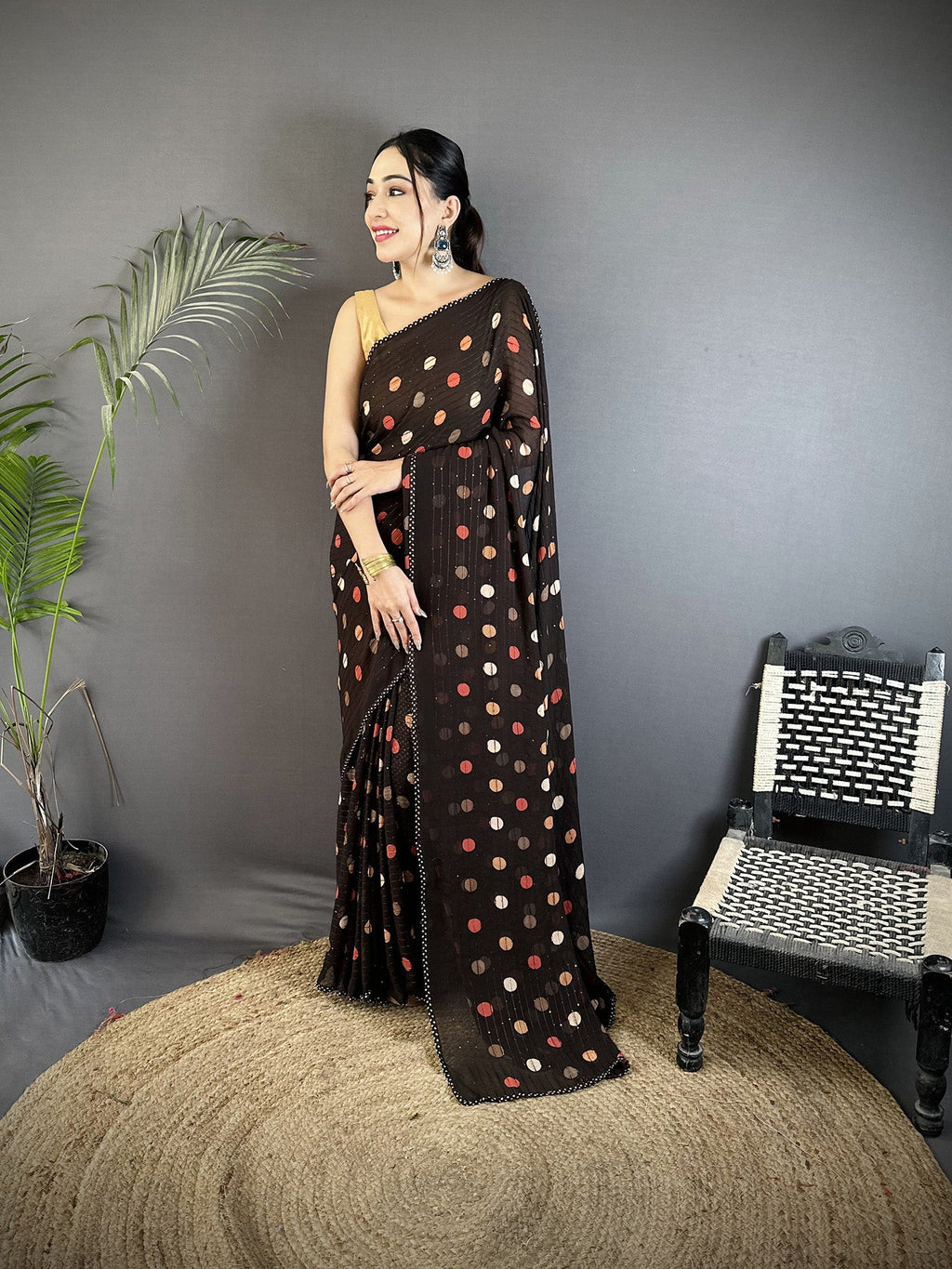 Black georgette saree with white polka dot pattern and matching blouse.