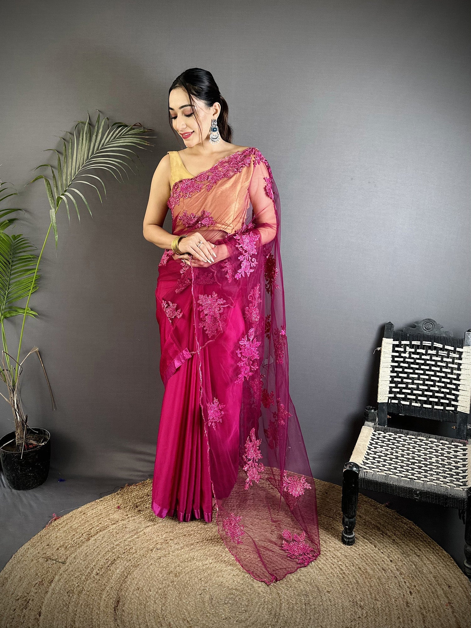 Fuchsia georgette saree with detailed floral embroidery pattern