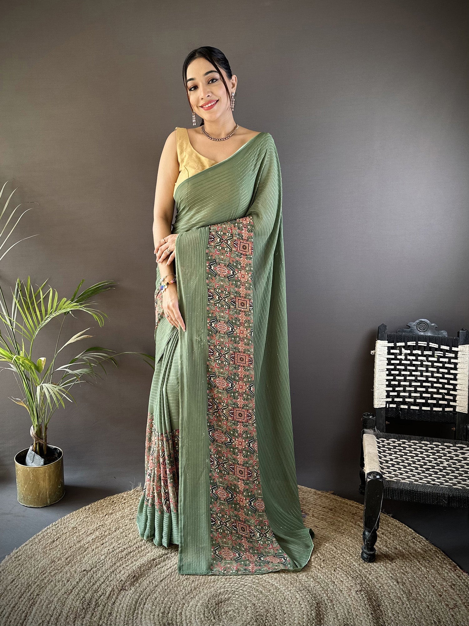 A beautiful Mehendi Green Georgette saree with an attractive gold foil print pattern