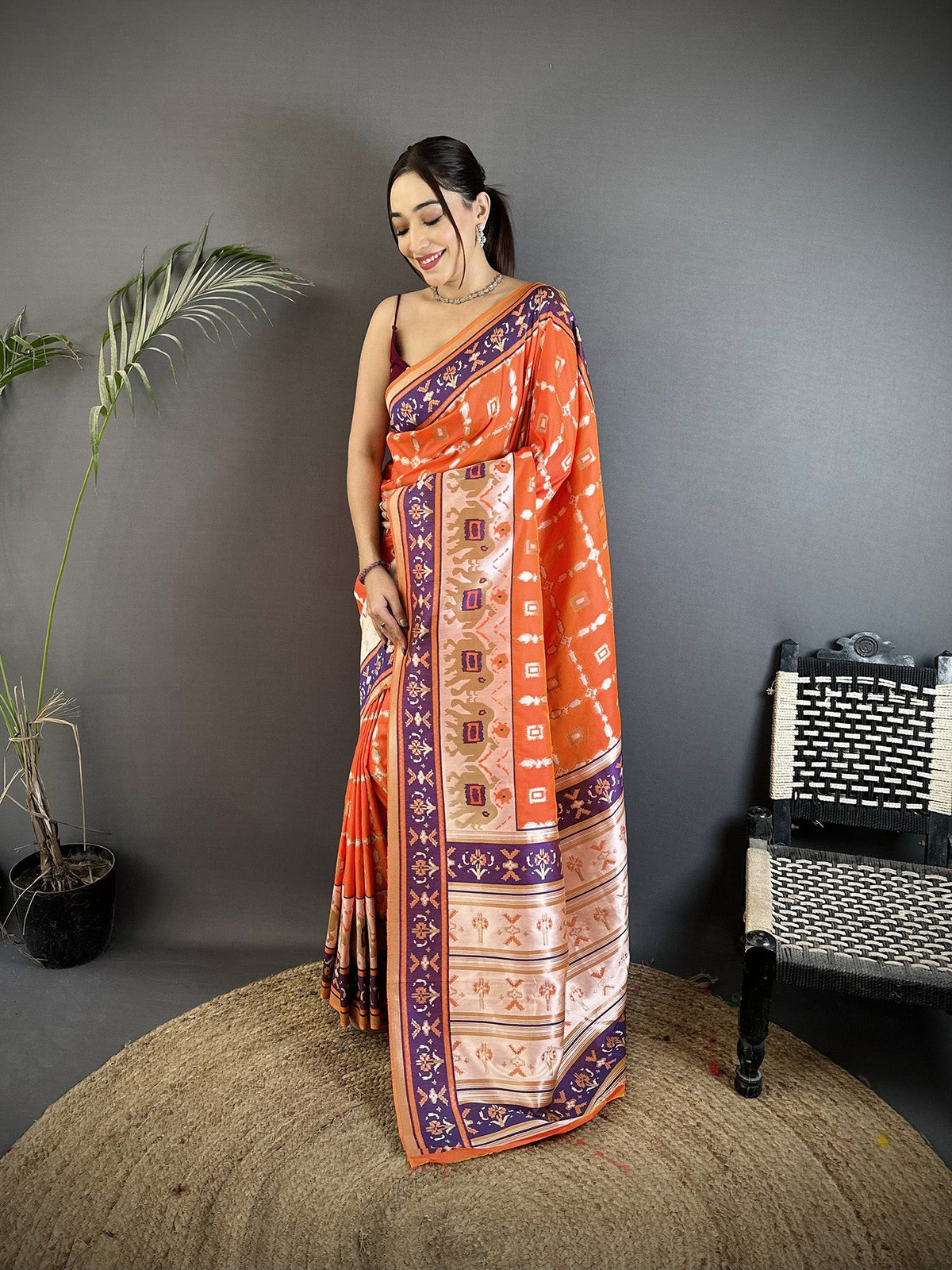 Orange Banarasi silk saree with delicate woven nature-inspired motifs