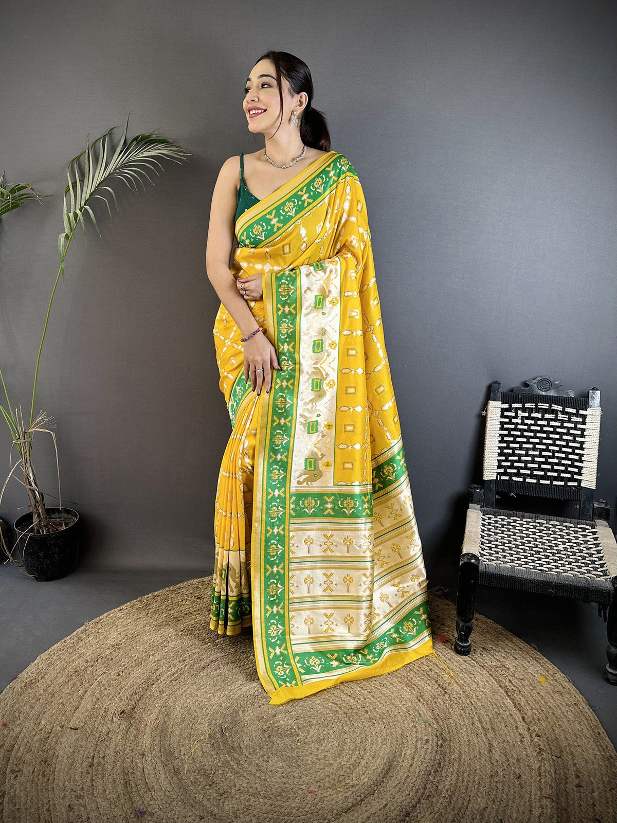 A yellow Banarasi silk saree with nature-inspired motifs, featuring an unstitched blouse piece.