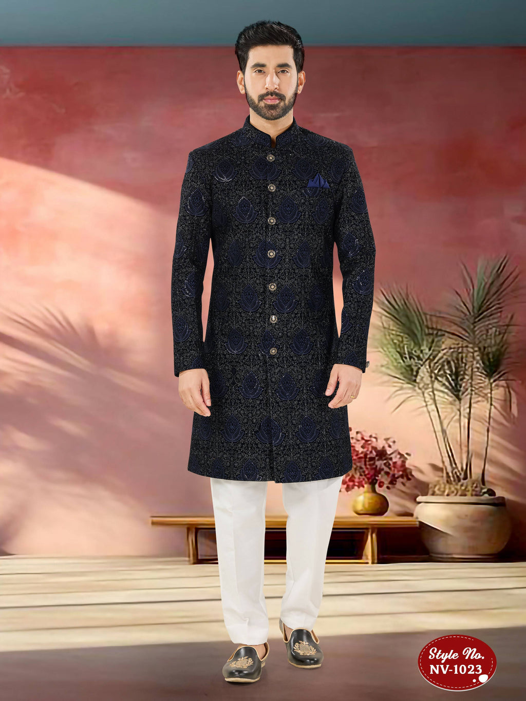 Man wearing a blue velvet Indo-Western kurta set with detailed thread and sequence embroidery