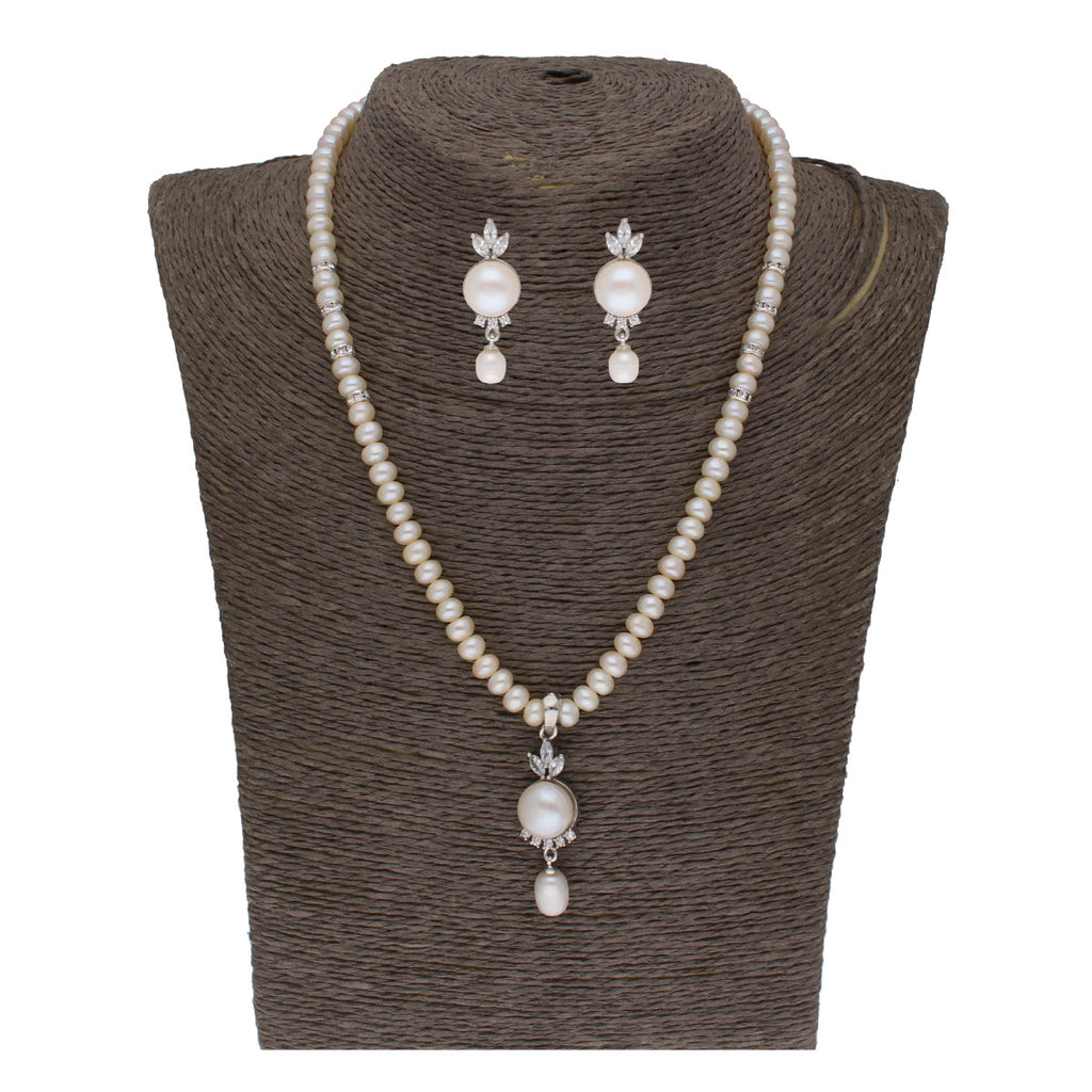 Close-up of a white fresh water pearl pendant set with CZ accents and gold plating