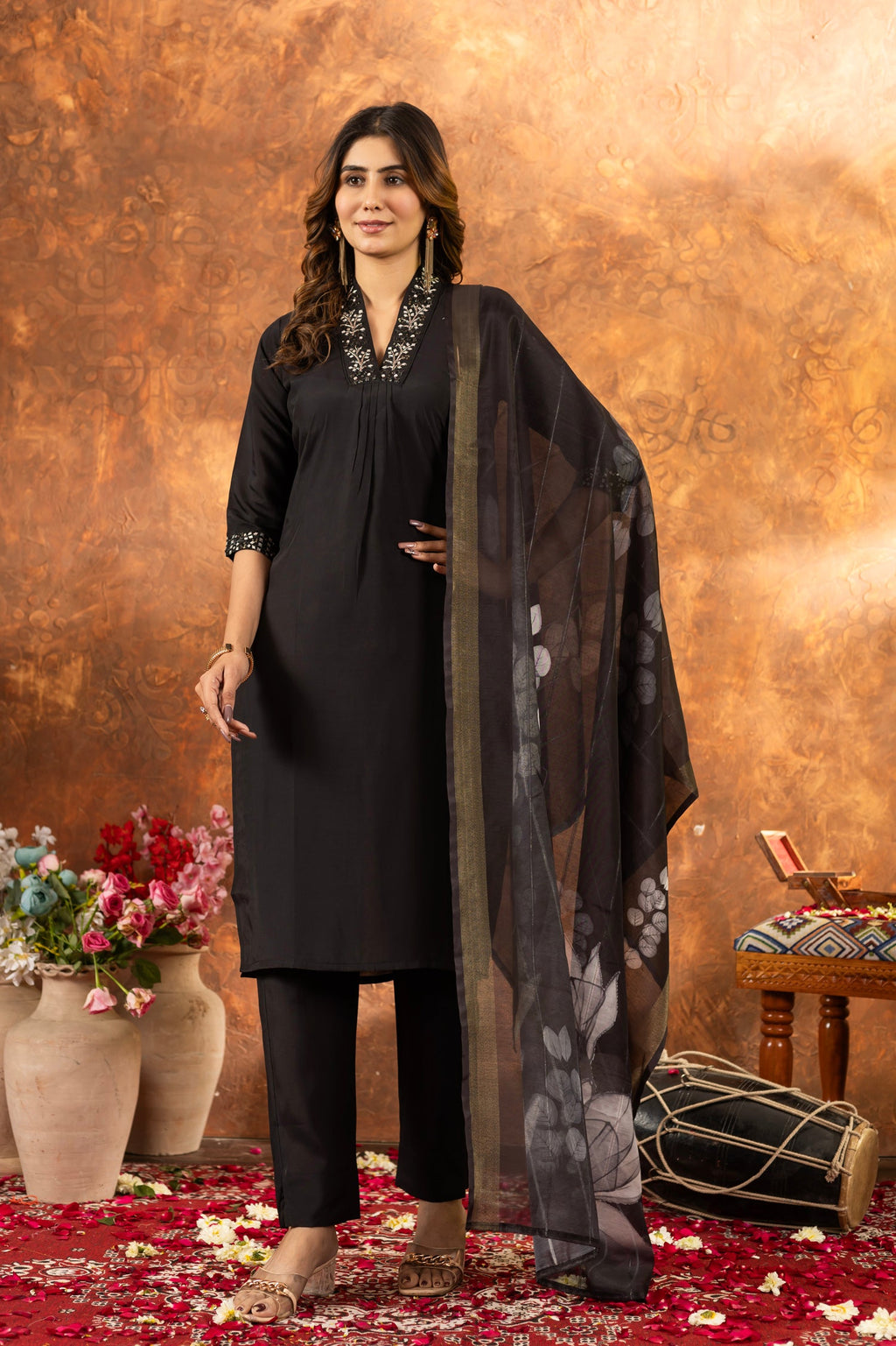 A black Roman Silk kurta set featuring sequins and hand-embroidered details with matching dupatta.