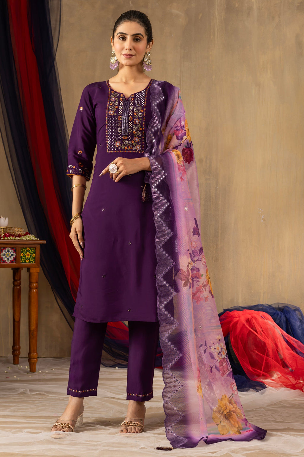 A beautiful purple Roman silk kurta set featuring multi-thread embroidery, hand-work, and sequins with matching pants and dupatta.