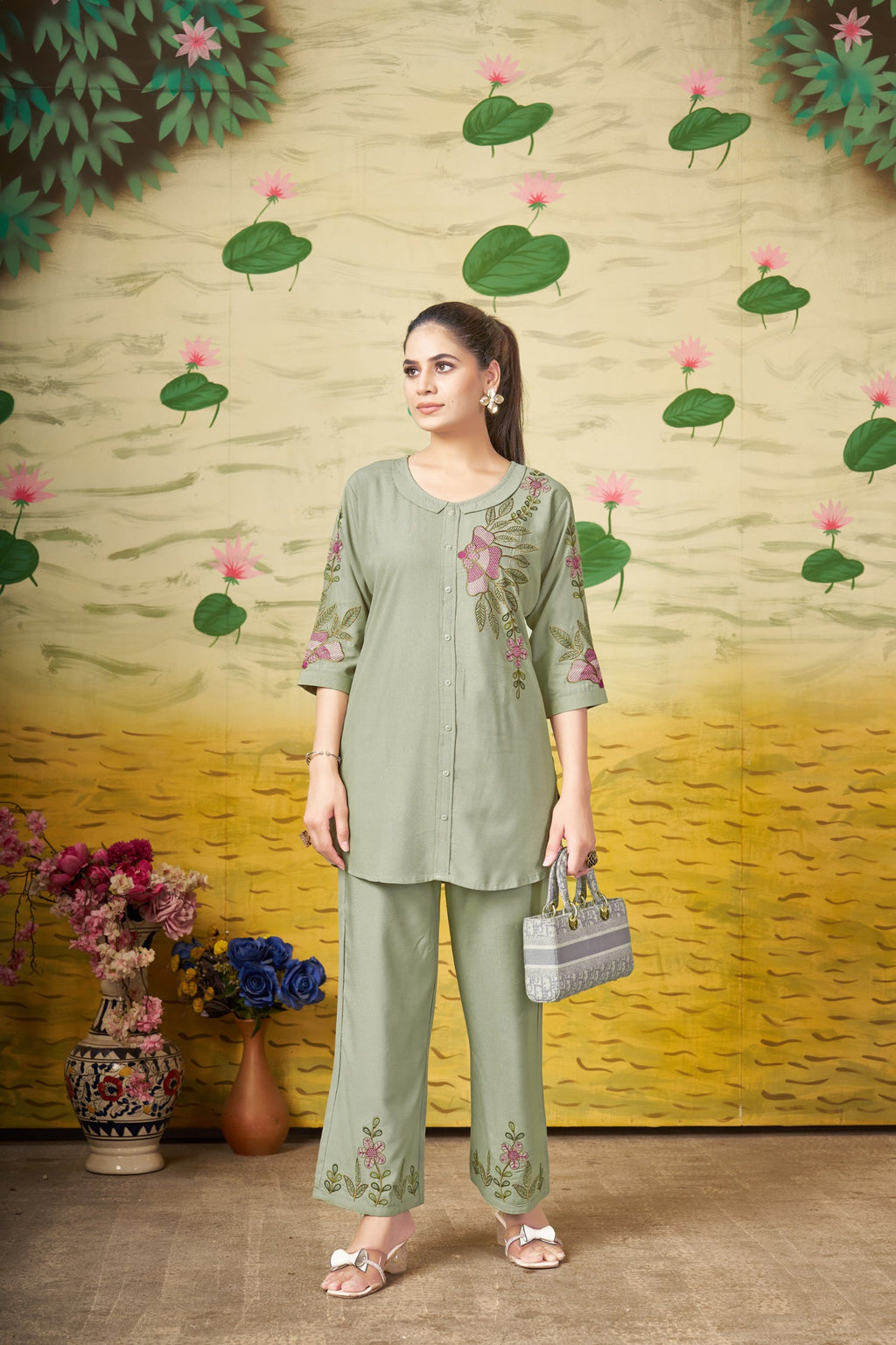 Woman wearing a Green Heavy Rayon Co-Ords Set with detailed multi-color embroidery thread work.