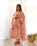 Women wearing a peach floral print faux georgette Anarkali kurta with a flared skirt and matching dupatta