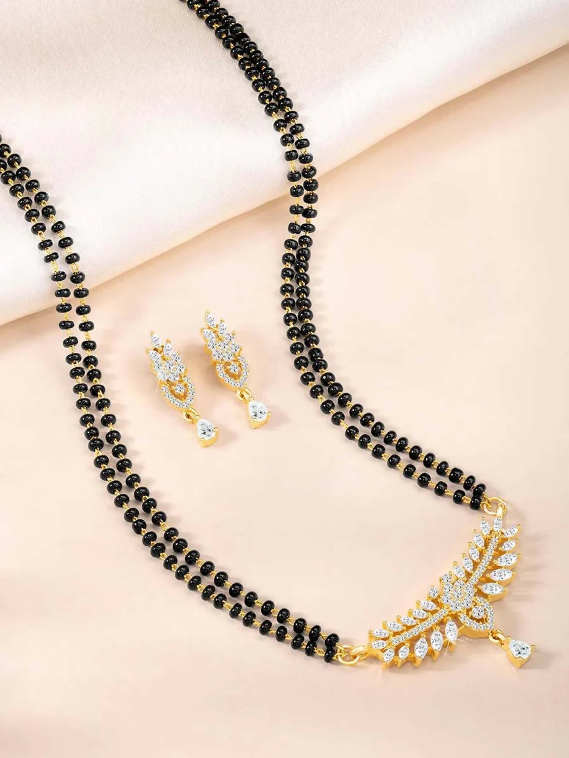 Elegant golden mangalsutra and matching earrings set for women featuring traditional design