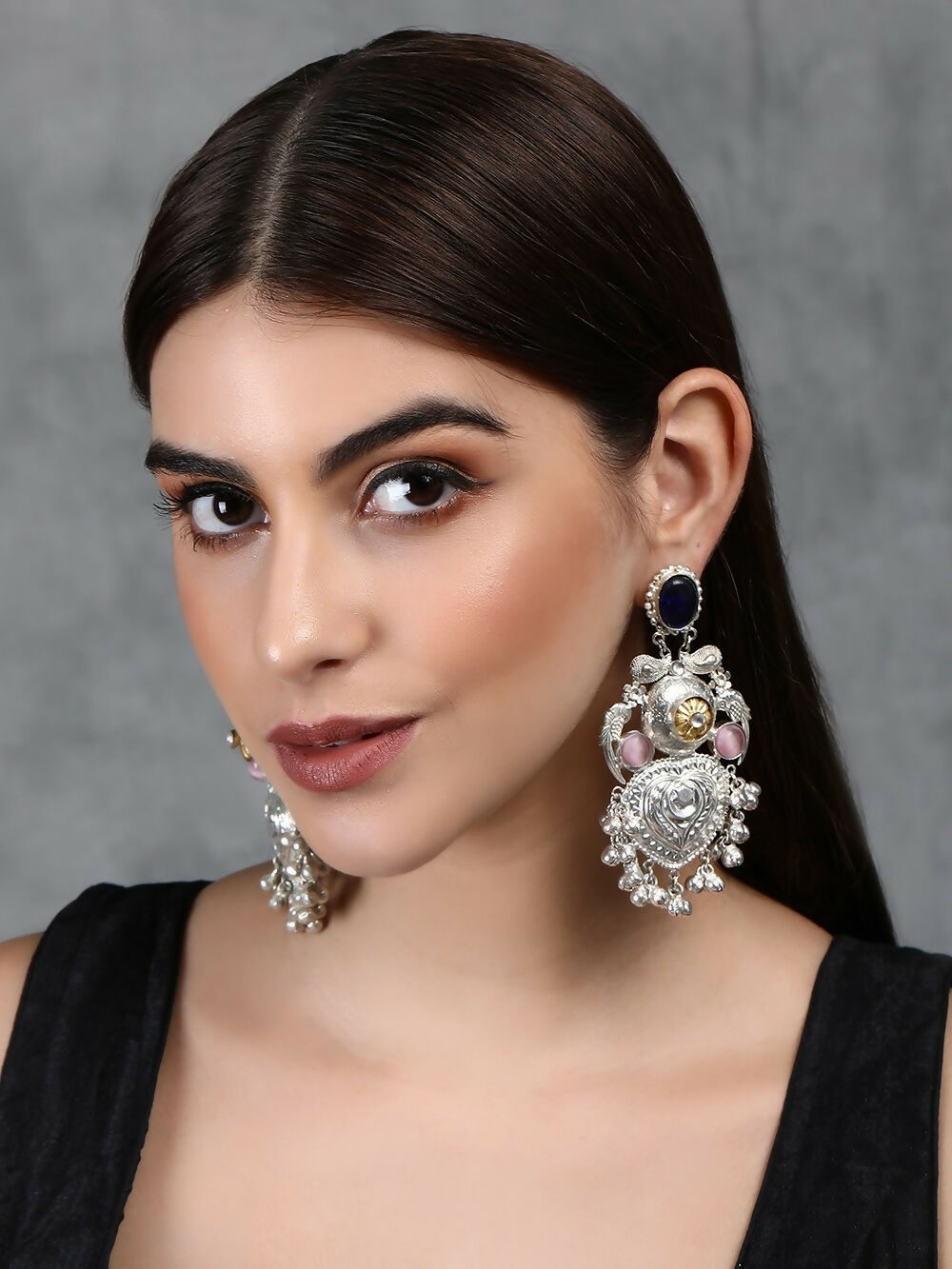 Handcrafted silver tone Ghungroo style earrings with intricate patterns and sparkling stone embellishments.