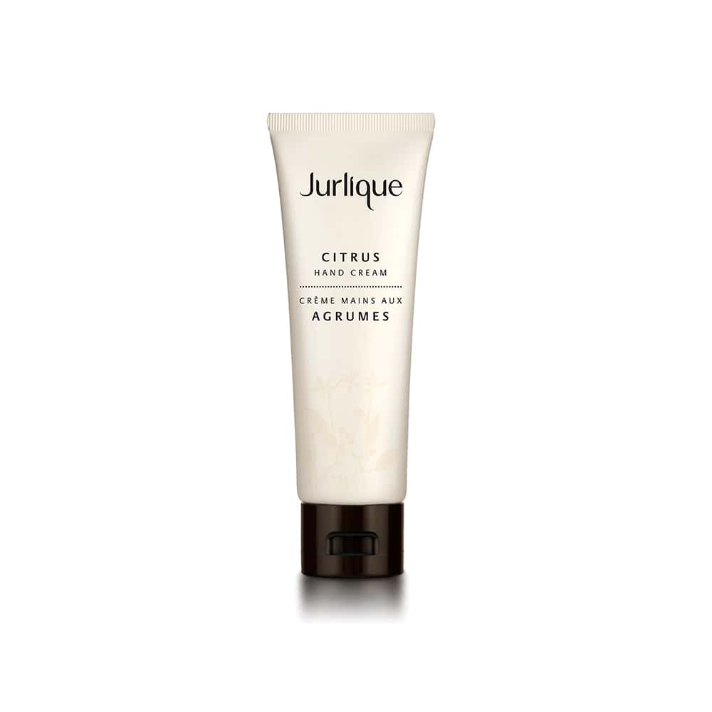 Jurlique Citrus Hand Cream 4.3 oz tube displayed with fresh citrus elements