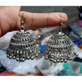 Silver tassel jhumka earrings with intricate beaded details and hook closure