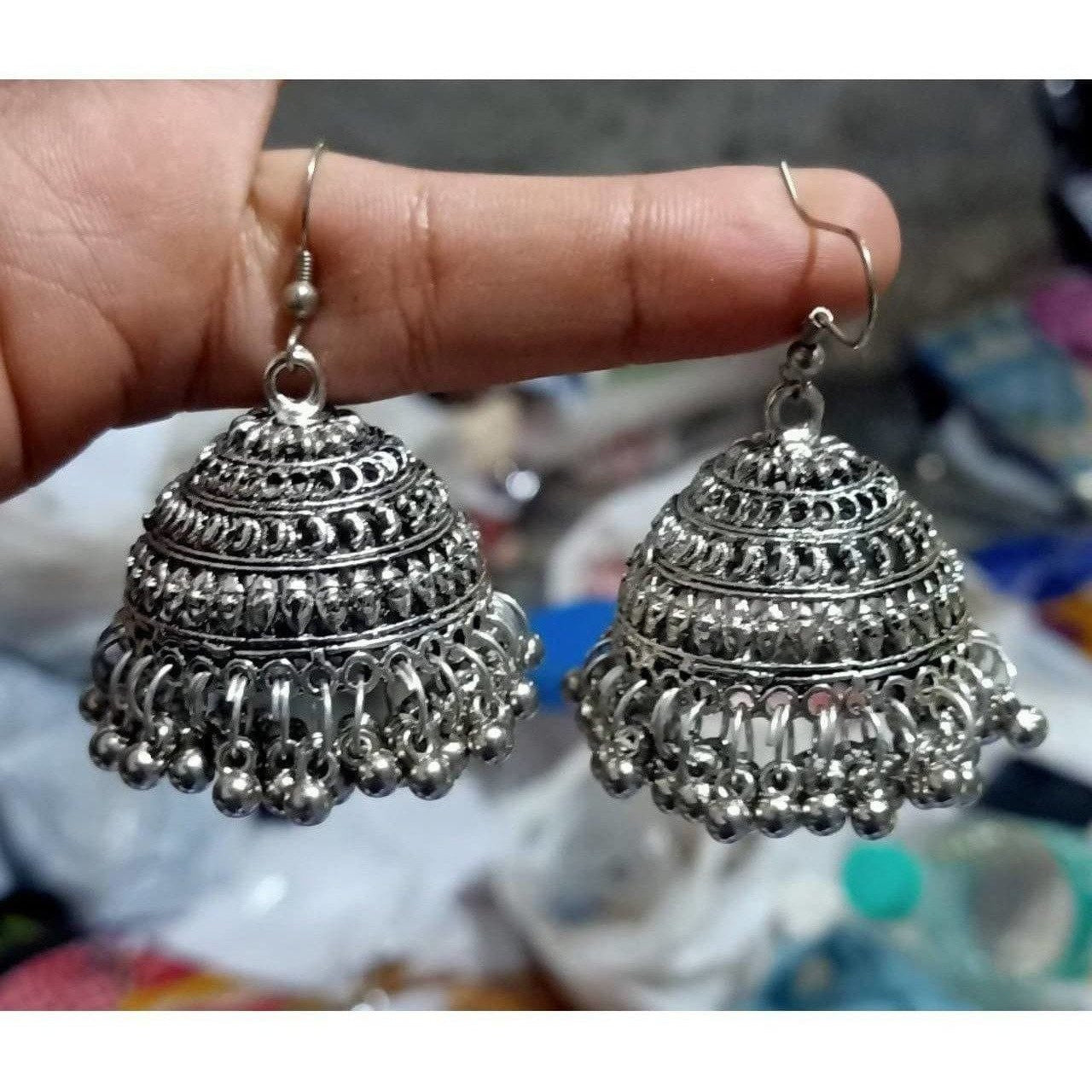 Silver tassel jhumka earrings with intricate beaded details and hook closure