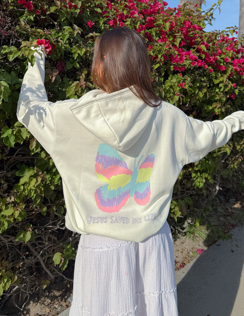 Jesus Saved My Life Unisex Hoodie in Cloud Dancer color worn by a model